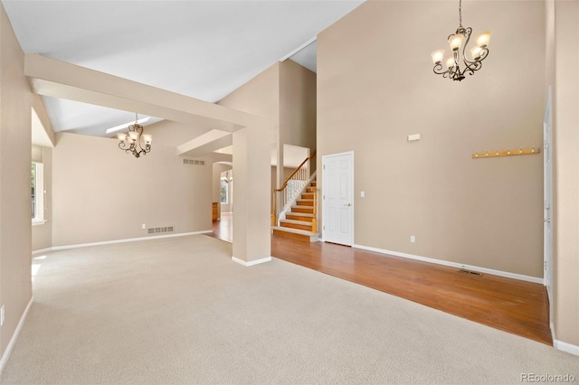 8985 Edgewood Ln, Highlands Ranch, CO 80130 - unfurnished living room with a chandelier, stairway, carpet flooring, baseboards, and a high ceiling