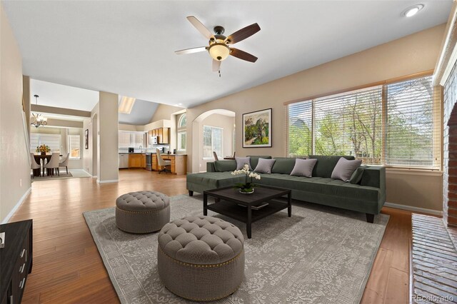8985 Edgewood Ln, Highlands Ranch, CO 80130 - living room with plenty of natural light, lofted ceiling, wood finished floors, ceiling fan, and arched walkways