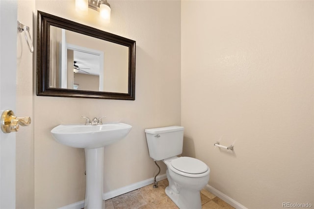 8985 Edgewood Ln, Highlands Ranch, CO 80130 - half bath with toilet, baseboards, and a sink