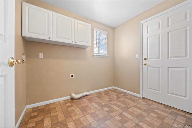 8985 Edgewood Ln, Highlands Ranch, CO 80130 - laundry area with cabinet space, baseboards, electric dryer hookup, and brick patterned floors