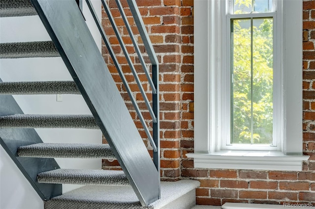 2193 Arapahoe St Unit 15, Denver, CO 80205 - stairs with brick wall and plenty of natural light
