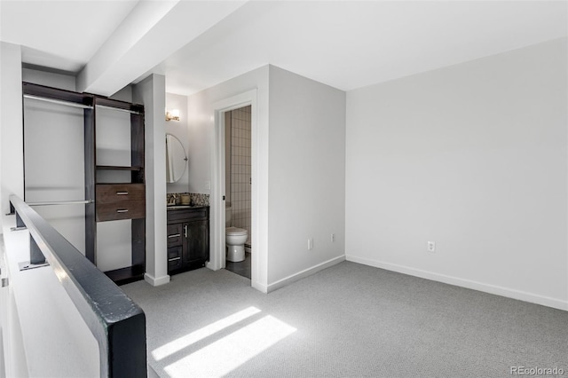 2193 Arapahoe St Unit 15, Denver, CO 80205 - unfurnished bedroom featuring baseboards, light carpet, and ensuite bath