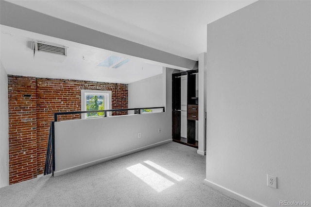 2193 Arapahoe St Unit 15, Denver, CO 80205 - empty room with carpet, baseboards, and brick wall