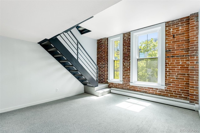 2193 Arapahoe St Unit 15, Denver, CO 80205 - unfurnished living room featuring plenty of natural light, carpet flooring, a baseboard radiator, and brick wall