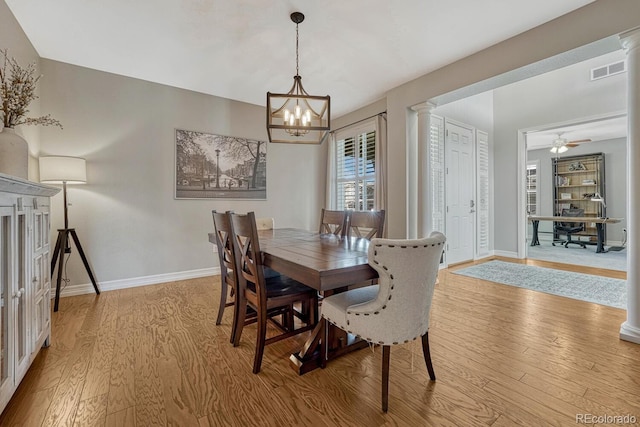 26566 E Peakview Dr, Aurora, CO 80016 - dining area featuring light wood-style floors, baseboards, decorative columns, and visible vents