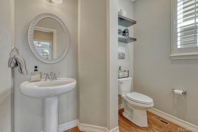 26566 E Peakview Dr, Aurora, CO 80016 - half bath with toilet, baseboards, visible vents, and wood finished floors