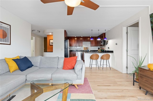 1150 Vine St Unit 306, Denver, CO 80206 - living room with light wood-type flooring, rail lighting, and ceiling fan