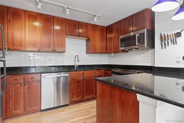 1150 Vine St Unit 306, Denver, CO 80206 - kitchen with appliances with stainless steel finishes, a sink, light wood-type flooring, and rail lighting