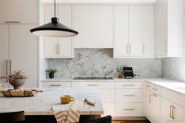 3130 Wyandot St, Denver, CO 80211 - kitchen with white cabinets, decorative backsplash, light stone counters, and black electric cooktop