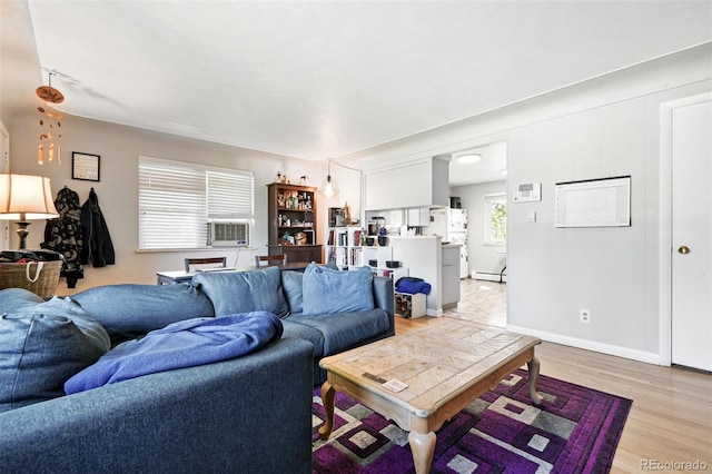 3691 Allison St, Wheat Ridge, CO 80033 - living area with light wood-style floors, a baseboard radiator, and baseboards