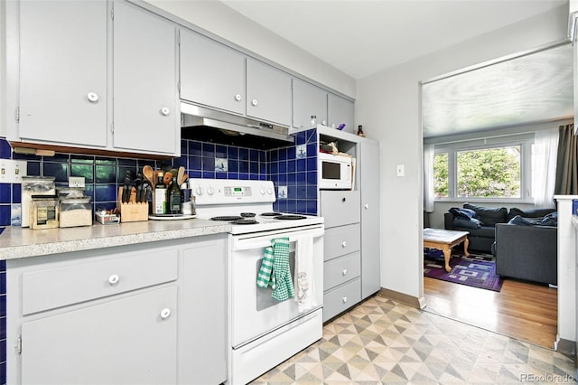3691 Allison St, Wheat Ridge, CO 80033 - kitchen featuring white appliances, under cabinet range hood, light countertops, light floors, and decorative backsplash