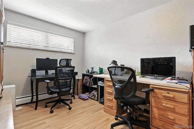 3691 Allison St, Wheat Ridge, CO 80033 - office area featuring light wood-style floors, a baseboard radiator, and a textured wall