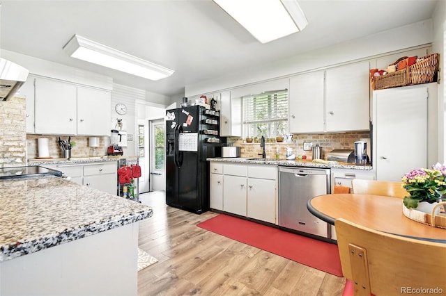 3691 Allison St, Wheat Ridge, CO 80033 - kitchen featuring black fridge with ice dispenser, stainless steel dishwasher, backsplash, light countertops, and plenty of natural light