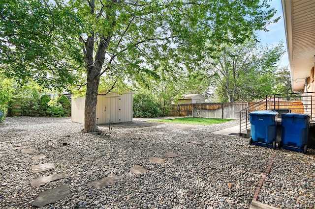 3691 Allison St, Wheat Ridge, CO 80033 - fenced backyard featuring a storage shed and an outbuilding