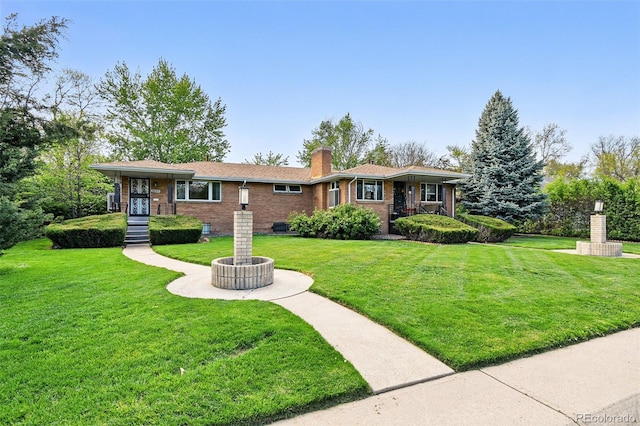 3691 Allison St, Wheat Ridge, CO 80033 - single story home with brick siding, a front yard, and a chimney