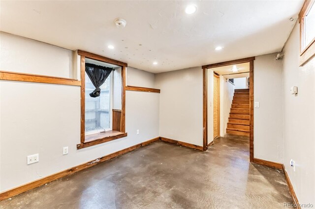 below grade area with stairs, baseboards, and recessed lighting