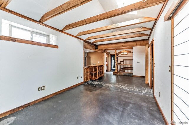 garage with fridge and baseboards