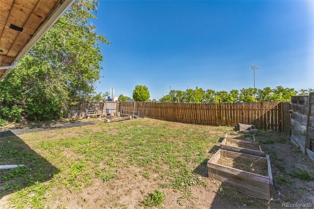 view of yard with a fenced backyard and a vegetable garden