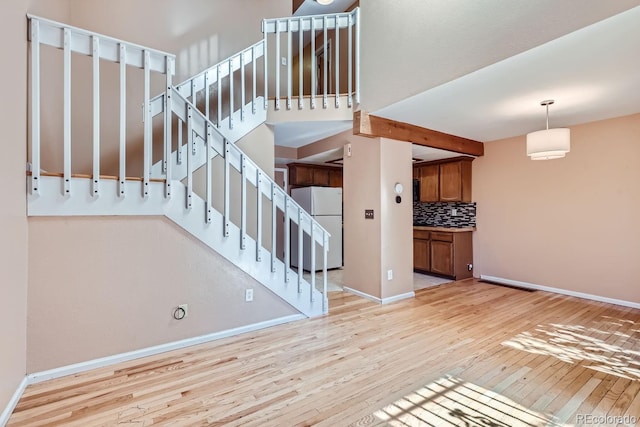 staircase with hardwood / wood-style flooring