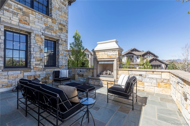 view of patio / terrace featuring an outdoor living space with a fireplace
