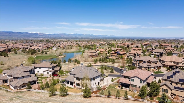 drone / aerial view featuring a residential view and a water and mountain view