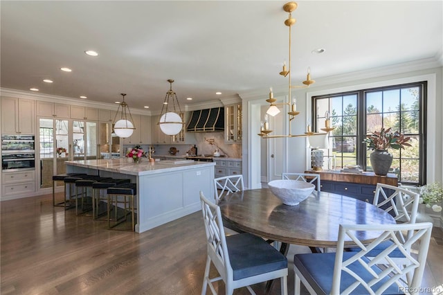 dining area featuring crown molding, recessed lighting, and dark wood-style floors