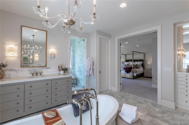 ensuite bathroom featuring an inviting chandelier, recessed lighting, a freestanding tub, ensuite bathroom, and a stall shower