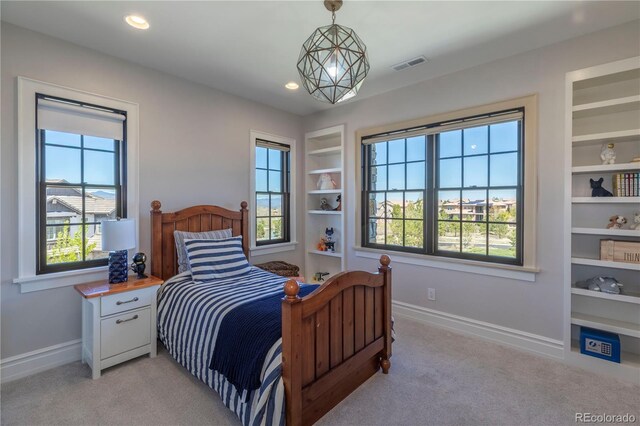 bedroom featuring light colored carpet, baseboards, and visible vents
