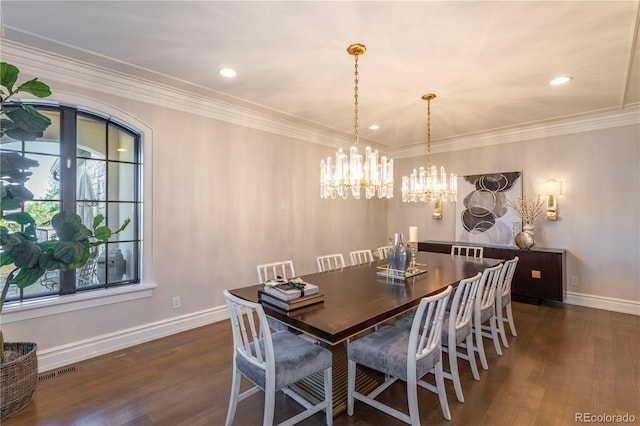 dining area featuring crown molding, visible vents, wood finished floors, baseboards, and a chandelier