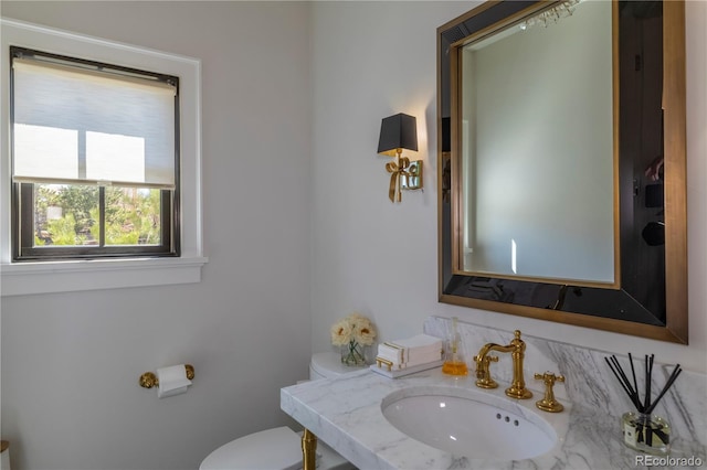 half bath with toilet and a sink