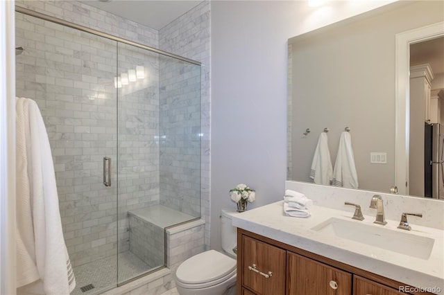 full bath featuring vanity, toilet, and a shower stall