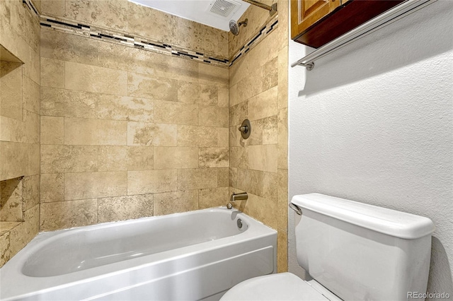 bathroom with toilet, a textured wall, shower / tub combination, and visible vents