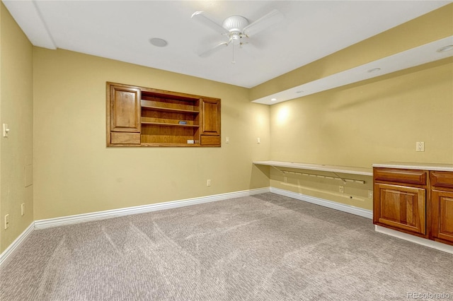 spare room with baseboards, a ceiling fan, and light colored carpet