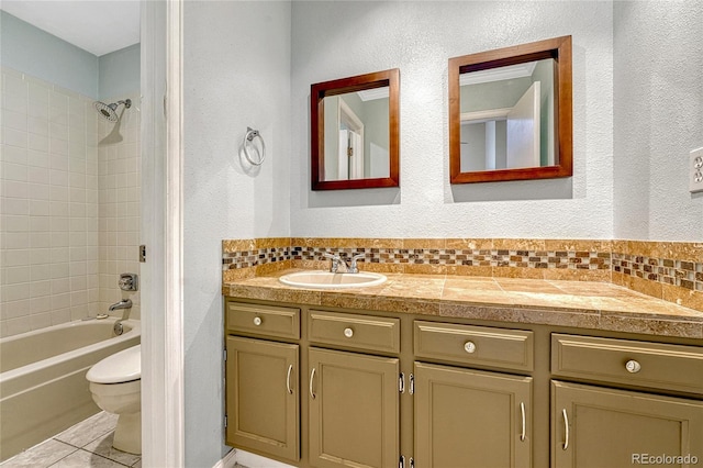 bathroom with a textured wall, toilet, shower / tub combination, tile patterned floors, and vanity