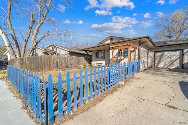 1940 Carmel Dr, Colorado Springs, CO 80910 - view of front of property featuring a porch, driveway, a garage, and a fenced front yard