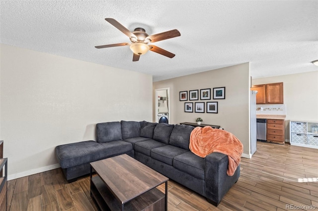 1940 Carmel Dr, Colorado Springs, CO 80910 - living area featuring washer / dryer, baseboards, wood finished floors, and ceiling fan