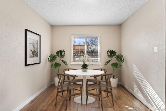 1940 Carmel Dr, Colorado Springs, CO 80910 - dining room featuring baseboards, wood finished floors, and a textured ceiling