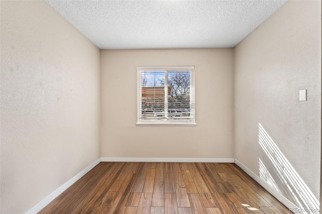 1940 Carmel Dr, Colorado Springs, CO 80910 - spare room with baseboards, wood finished floors, and a textured ceiling