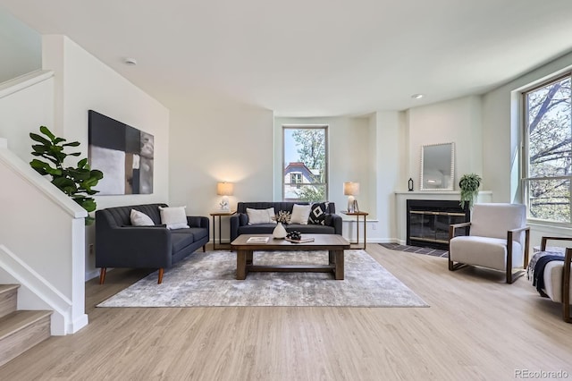 2120 W 31st Ave, Denver, CO 80211 - living room featuring baseboards, stairway, a tile fireplace, and wood finished floors