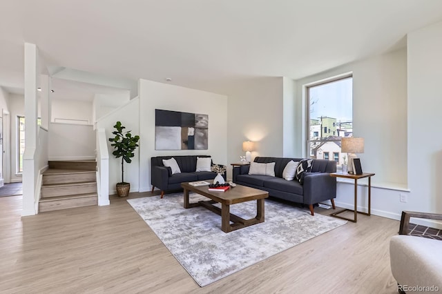 2120 W 31st Ave, Denver, CO 80211 - living area with stairs, baseboards, and light wood-style floors