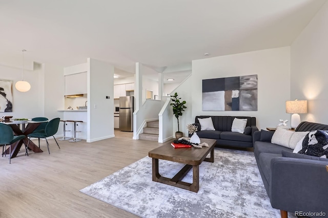 2120 W 31st Ave, Denver, CO 80211 - living area with stairway, light wood-style flooring, and baseboards