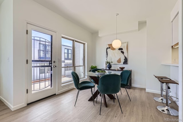 2120 W 31st Ave, Denver, CO 80211 - dining area featuring baseboards and light wood-style flooring