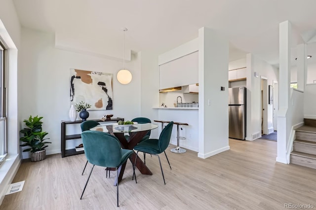 2120 W 31st Ave, Denver, CO 80211 - dining room with baseboards, light wood finished floors, and visible vents