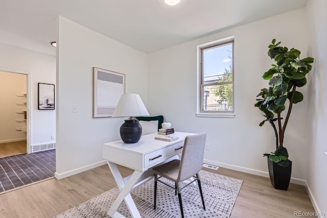2120 W 31st Ave, Denver, CO 80211 - home office with light wood-style floors and baseboards