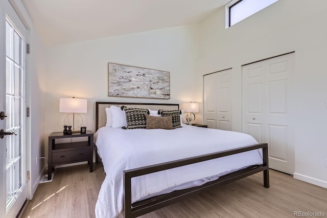 2120 W 31st Ave, Denver, CO 80211 - bedroom featuring baseboards, high vaulted ceiling, and wood finished floors
