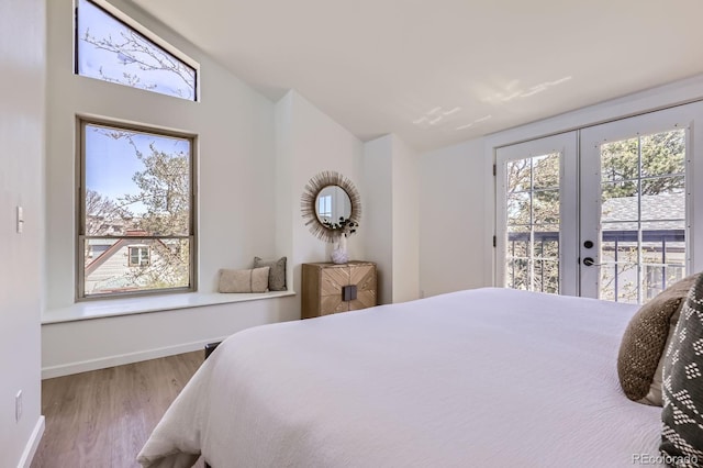 2120 W 31st Ave, Denver, CO 80211 - bedroom with lofted ceiling, french doors, baseboards, wood finished floors, and access to exterior