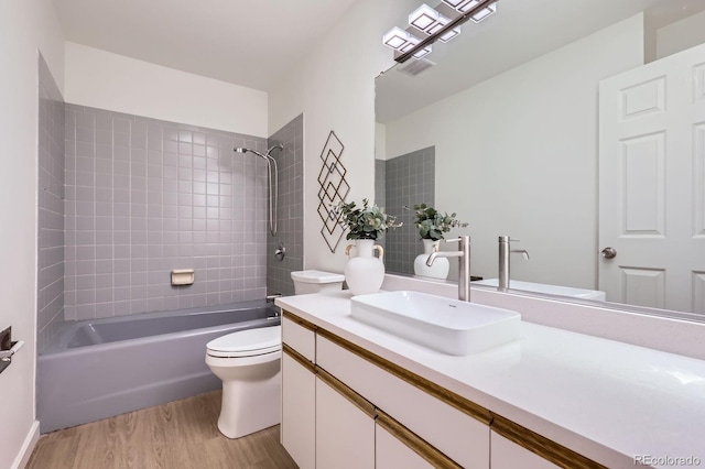 2120 W 31st Ave, Denver, CO 80211 - bathroom with shower / bathtub combination, toilet, visible vents, vanity, and wood finished floors