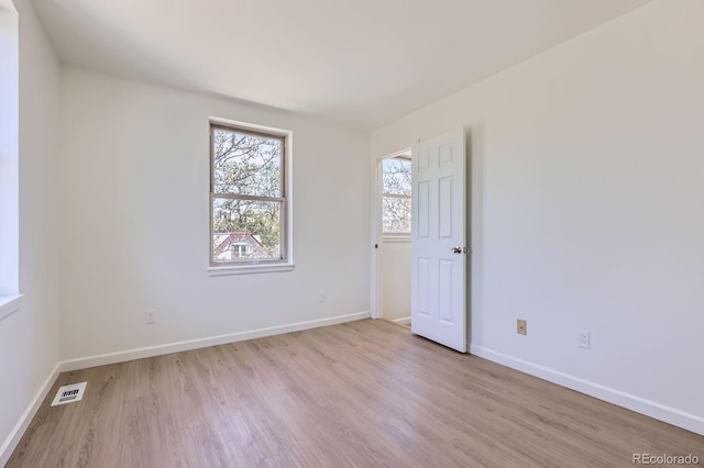 2120 W 31st Ave, Denver, CO 80211 - empty room featuring baseboards, light wood-style floors, and visible vents