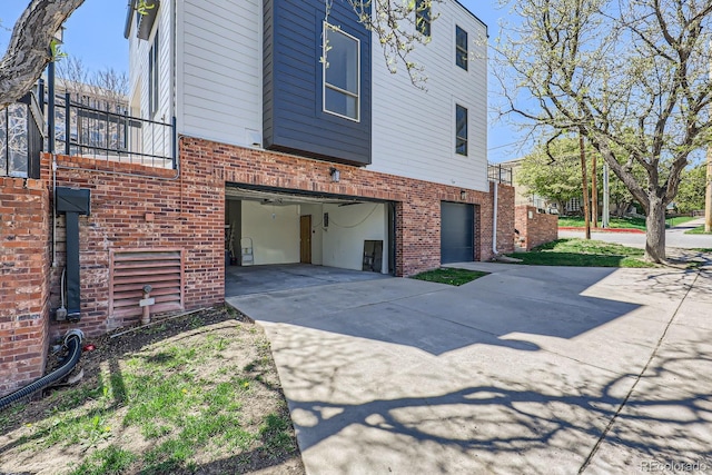 2120 W 31st Ave, Denver, CO 80211 - view of property exterior with driveway, brick siding, and a garage