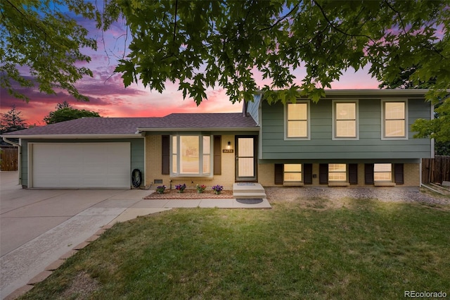 16135 E Baker Pl, Aurora, CO 80013 - tri-level home with driveway, an attached garage, and brick siding